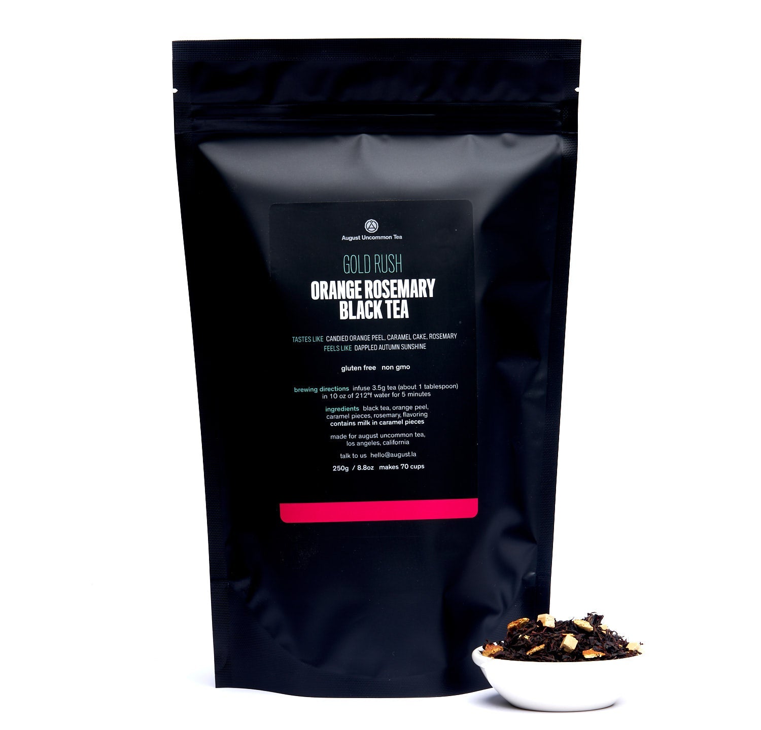 August Gold Rush - Orange Rosemary Caramel Black Tea in a tasting cup, displayed with a notebook for tea tasting notes.