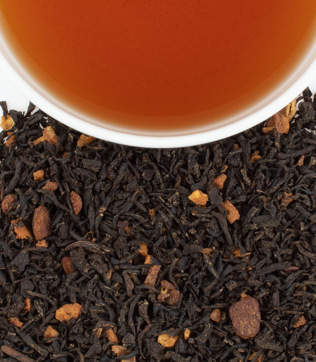 Harney & Sons Williamsburg Holiday Heritage Tea in a tin, containing 20 sachets, shown in a cup with holiday decorations.