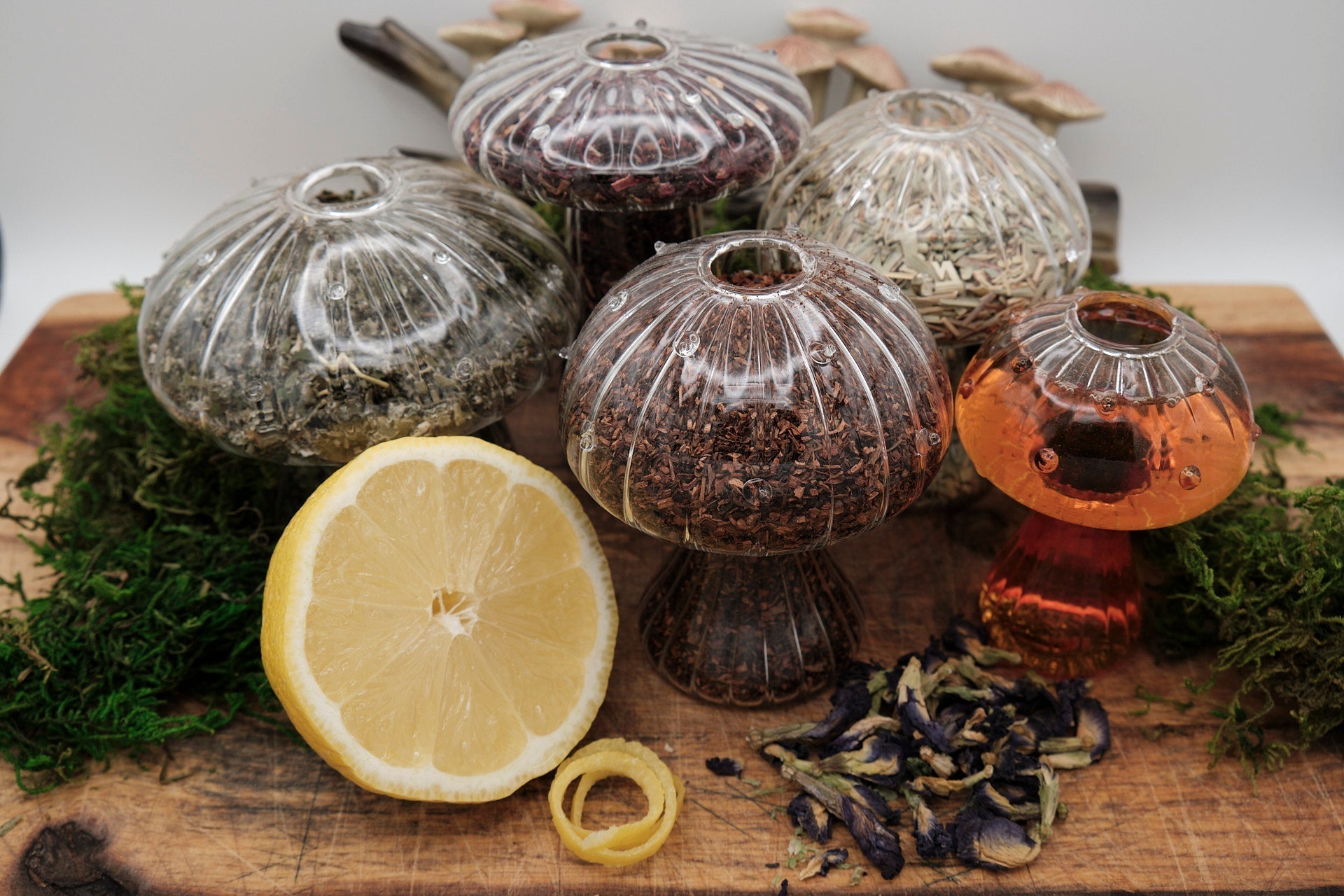 Morelitea Lemonlight Elixir Fairy Loose Leaf Tea in a clear glass container, showcasing loose tea leaves and citrus bits.