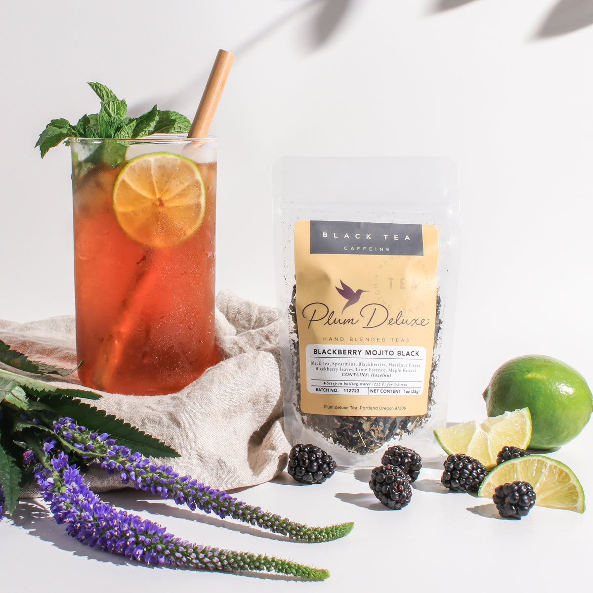 Plum Deluxe Blackberry Mojito Black Tea featuring lime, maple, and spearmint in a lifestyle setting.