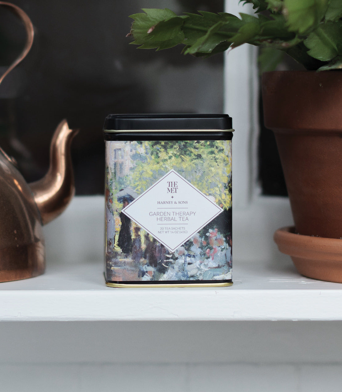 Harney & Sons Garden Therapy Herbal Tea, Tin of 20 sachets, displayed in a mood setting with herbal tea elements.