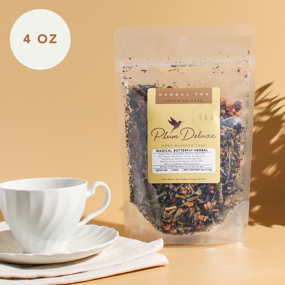 Plum Deluxe Magical Butterfly Herbal Tea, 4 oz package featuring butterfly pea flower and berries, shown in packaging.