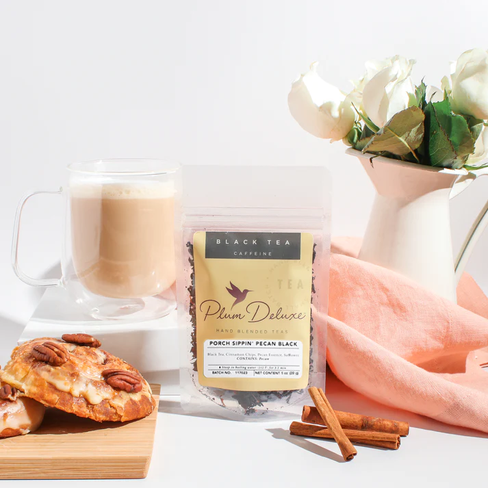 Plum Deluxe Porch Sippin' Pecan Black Tea in a lifestyle setting, showcasing the tea leaves and packaging.