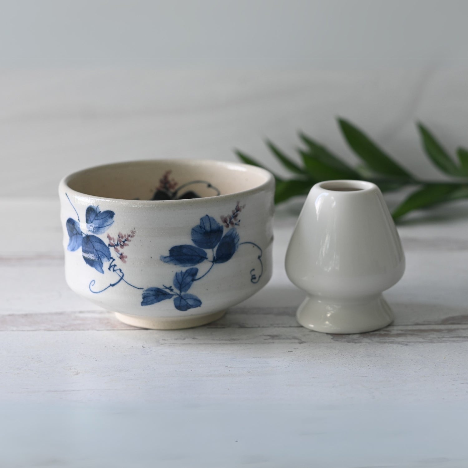 Aprika Life White Clay Kudzu Flowers Matcha Bowl featuring a floral design, suitable for preparing and serving matcha tea.