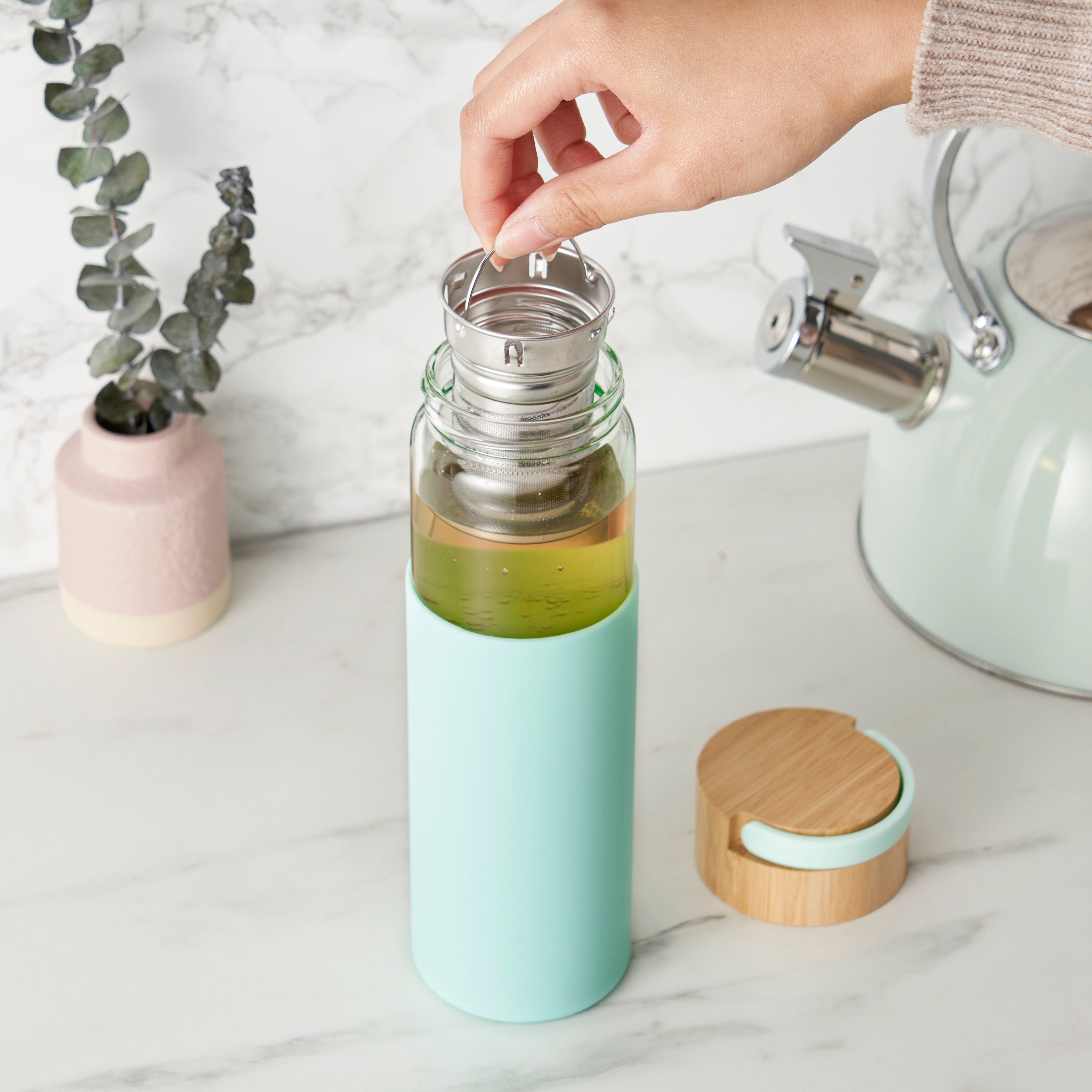 Pinky Up Dana Glass Travel Mug in Turquoise, a stylish and functional travel mug for beverages on the go.
