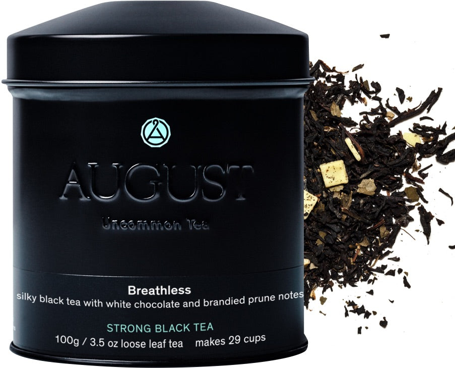 August Breathless - White Chocolate Plum Black Tea in a clear glass cup with loose tea leaves and fruit pieces displayed.
