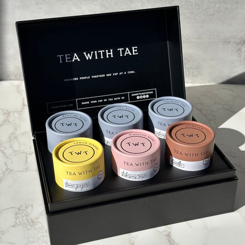 Caffeine Free Tea Bento Box by Tea with Tae featuring six mini tea tubes with assorted herbal teas and sachets.