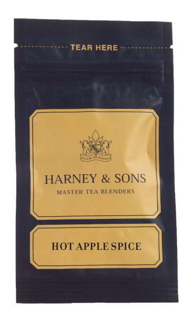 Harney & Sons Hot Apple Spice tea blend packaged in a bag, shown on a wooden surface