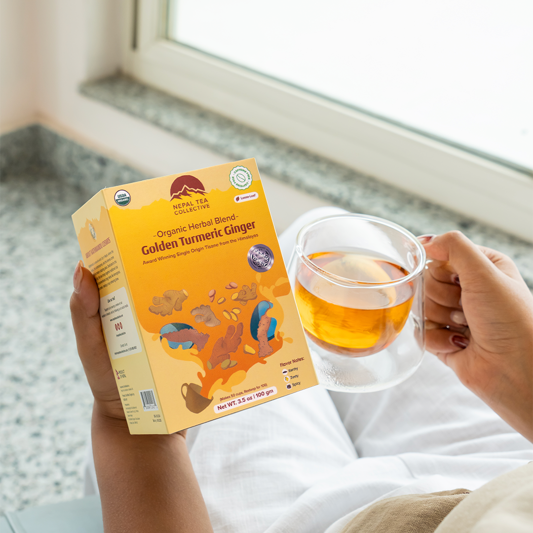 Golden Turmeric Ginger by Nepal Tea, featuring dried turmeric and ginger roots in a clear package