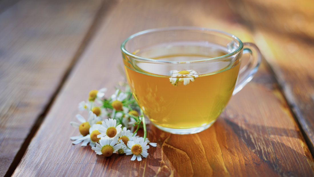 A cup of chamomile tea (not ginger tea) in a glass cup on a wooden table, a popular beverage known for its health benefits and calming properties, often used as a natural remedy to fall asleep, improve sleep quality, and support digestive health while aid