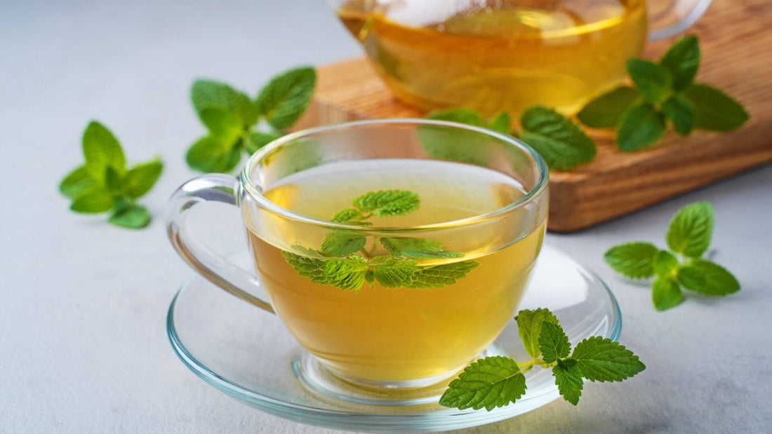 A lemon balm tea in a glass teacup