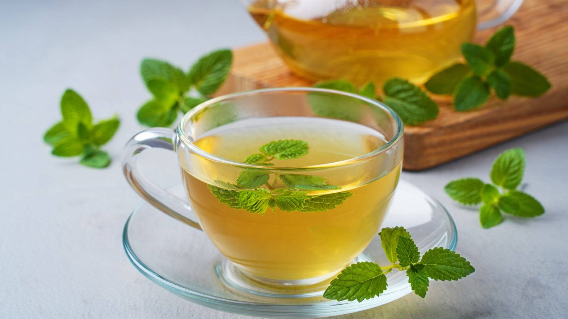 A lemon balm tea in a glass teacup