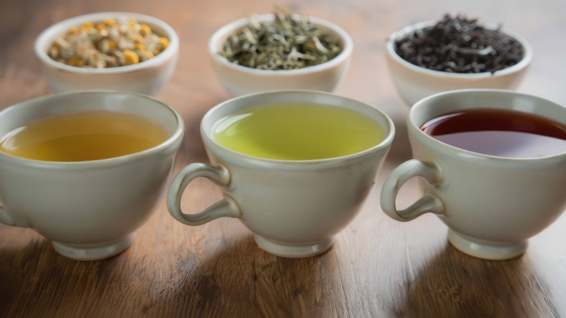Herbal tea, green tea, and black tea in a teacup