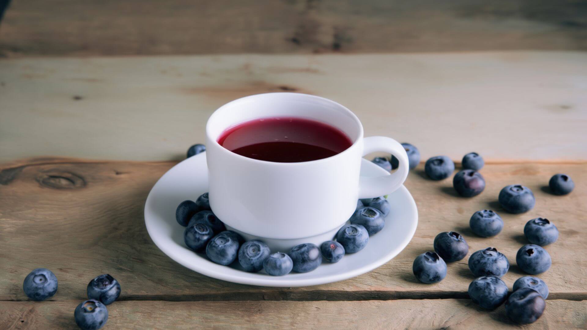 Blueberry tea surrounded by blueberries