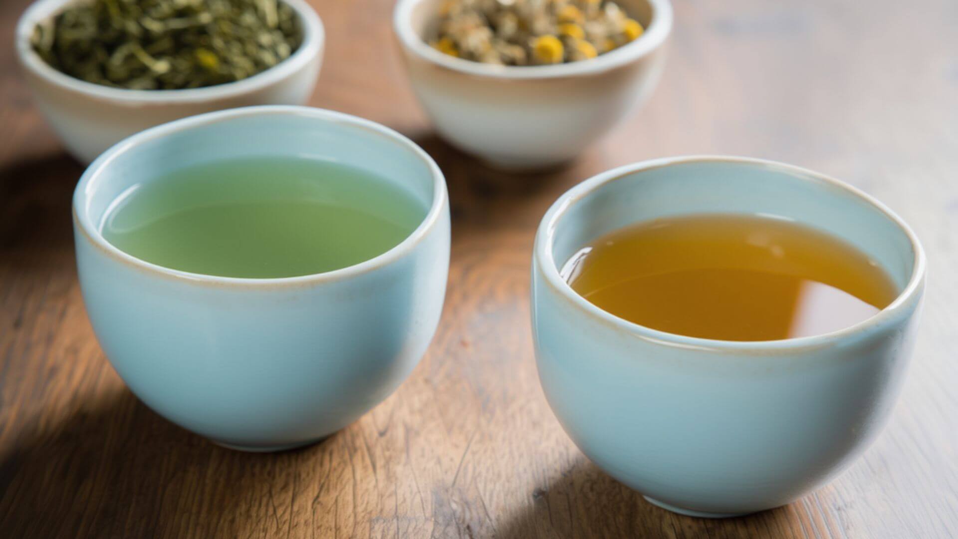 Green tea and chamomile tea in a teacup