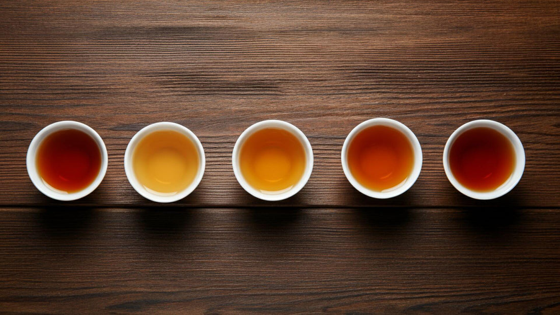 Five teacups of different types of black teas are arranged in a row