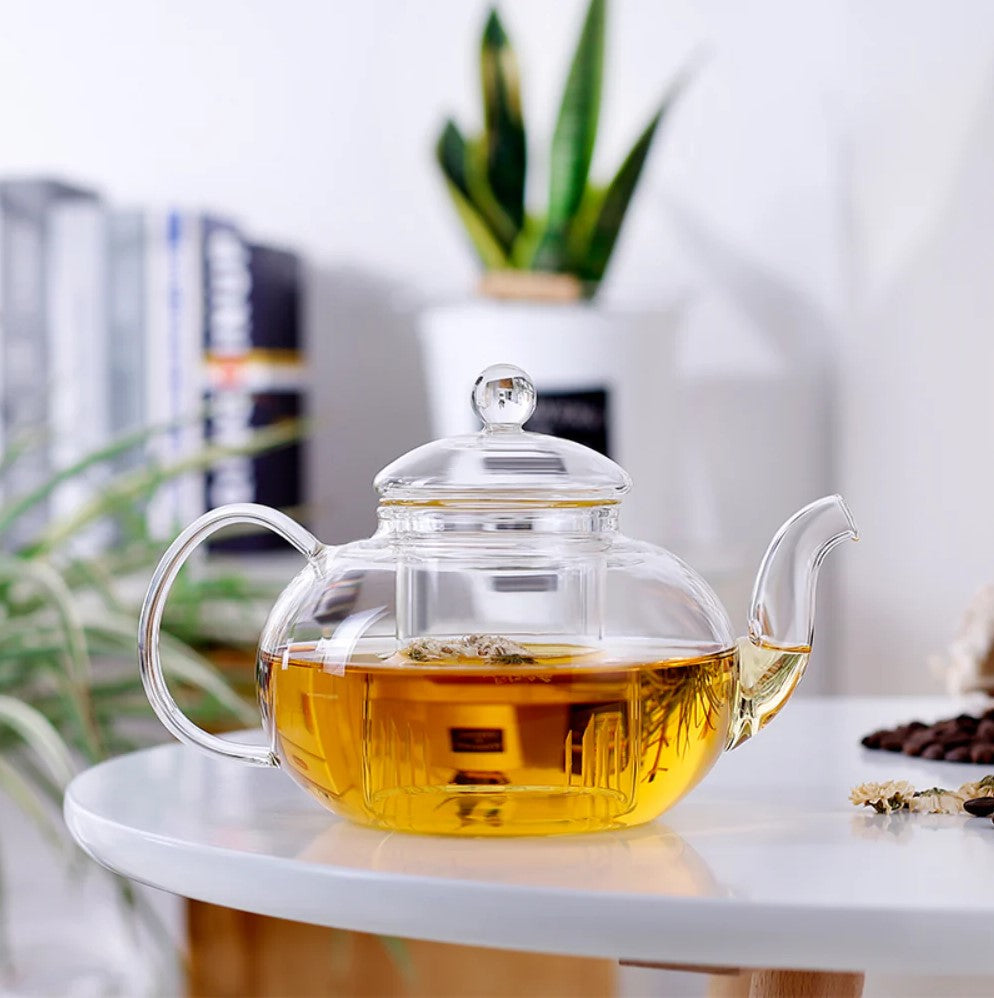 Glass kettle with built-in tea infuser on a table
