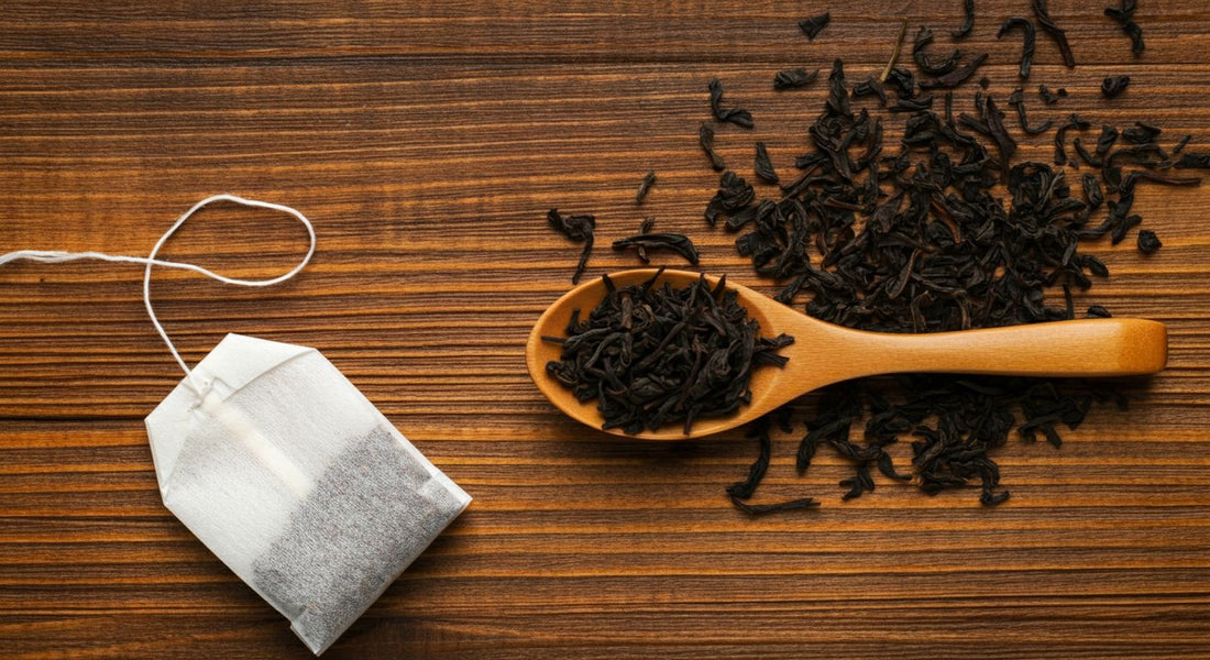 "A side-by-side comparison of loose leaf tea and tea bags, showing whole loose leaf tea leaves and tea bags on a wooden tray."