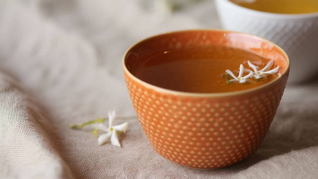 A jasmine tea in a brown tea cup