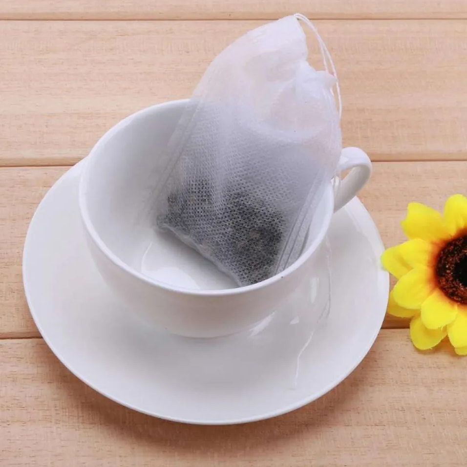Tea filter with loose leaf tea on a white cup with a white saucer