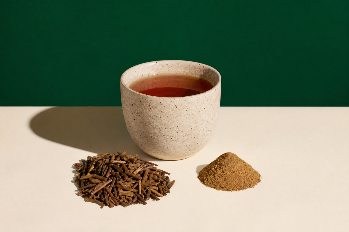 A handmade matte speckled stoneware cup of clear reddish-brown roasted hojicha tea