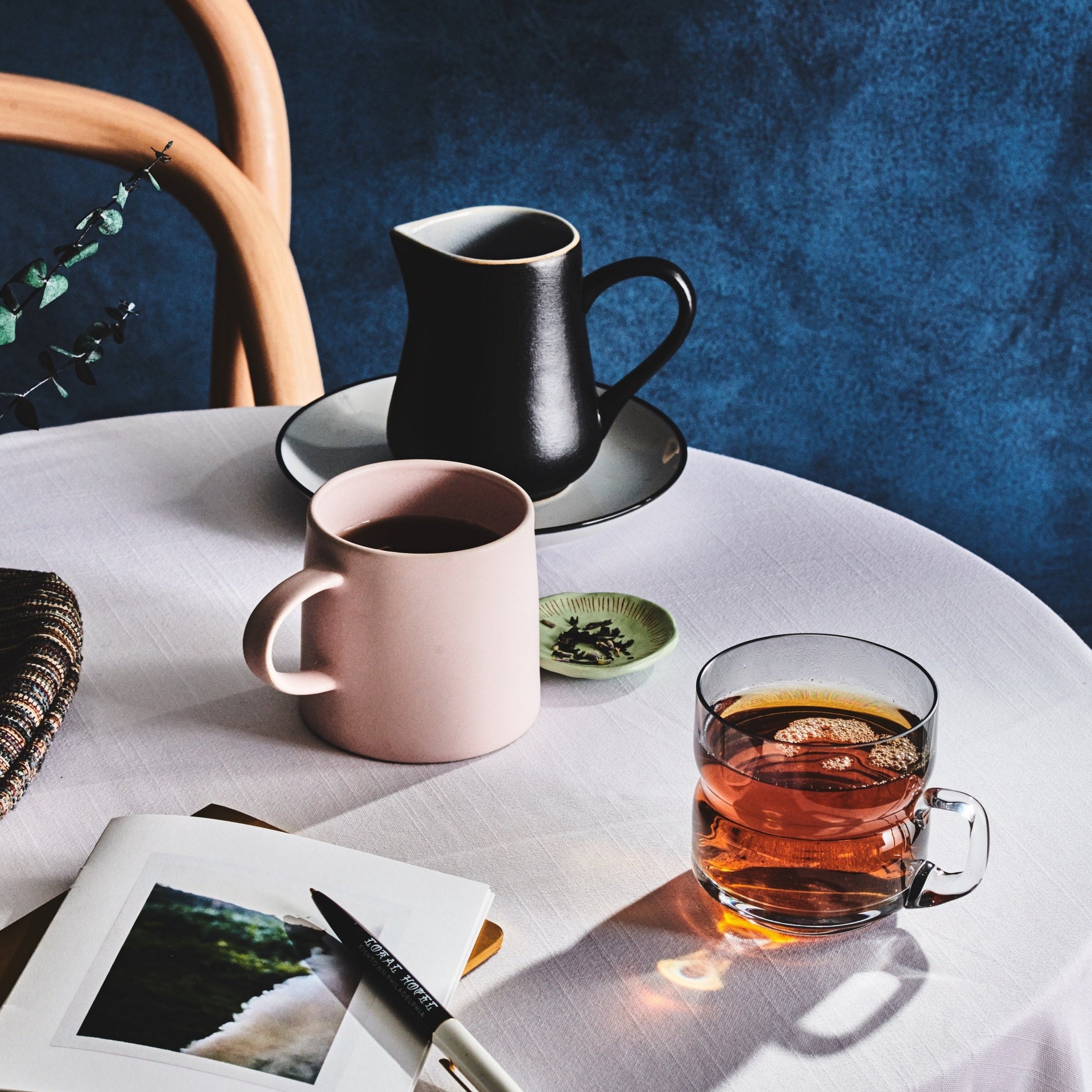 Lavender Earl Grey tea set on a table with a pink mug, and a black teapot