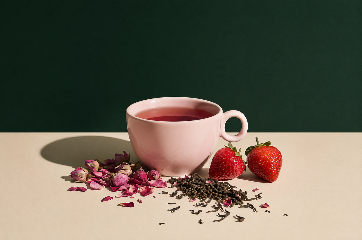Valentine's Day tea: pink cup of rose tea with rose petals and strawberries
