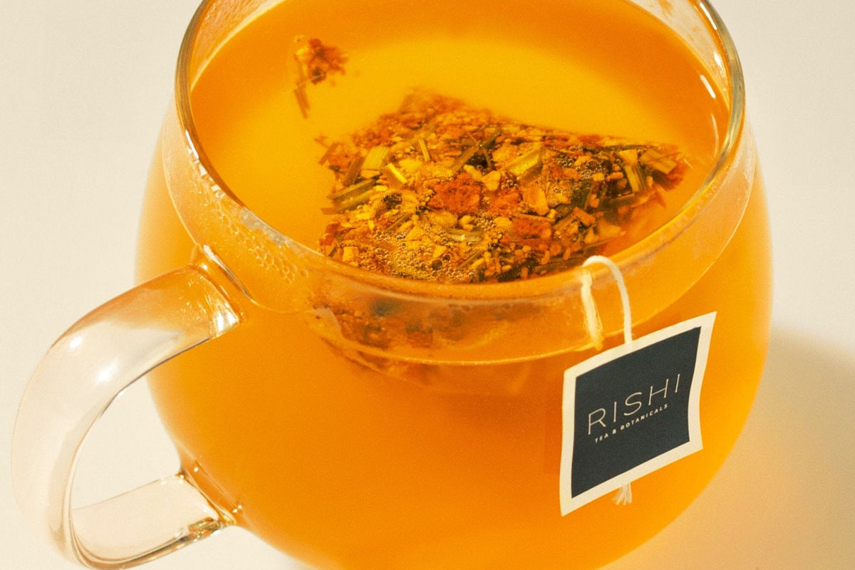 Rishi tea sachet steeping in a glass mug