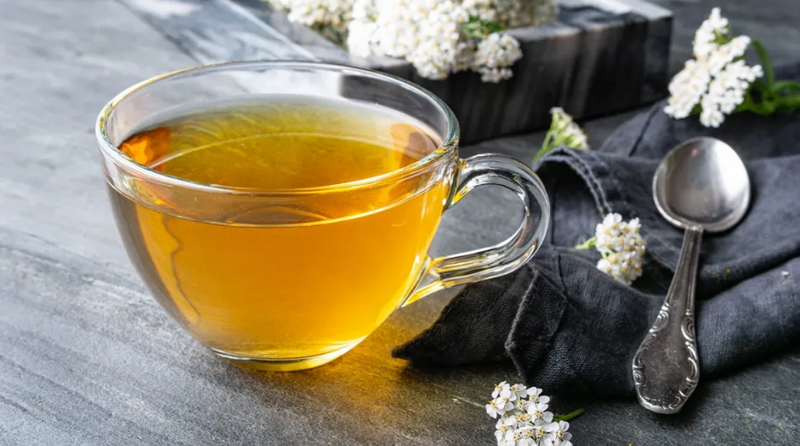 Freshly brewed yellow tea in a glass cup with light golden hue
