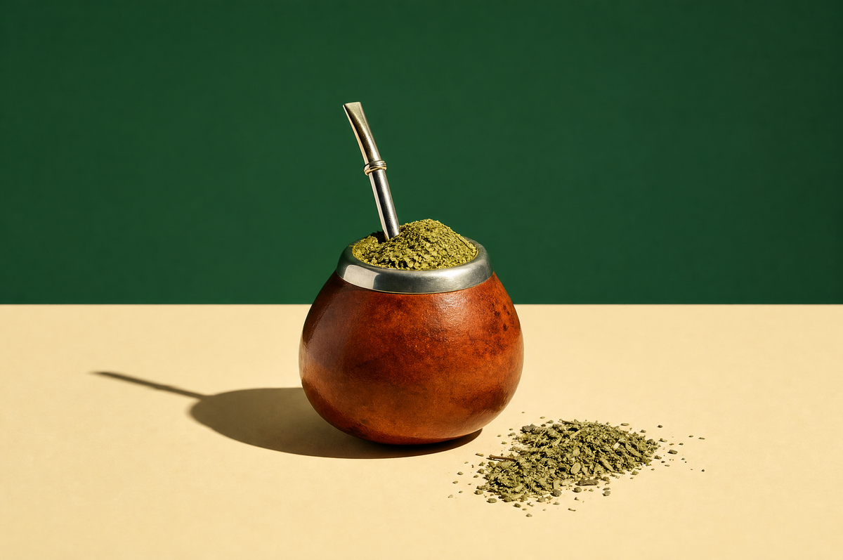 A traditional round calabash mate gourd heaped with bright green finely cut yerba mate leaf