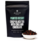 August Painted Desert - Chocolate Chili Black Tea in a bag, showcasing the product for brewing in a cup.