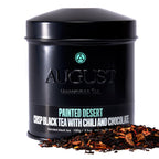 August Painted Desert - Chocolate Chili Black Tea in a decorative tin, featuring a colorful painted desert design.