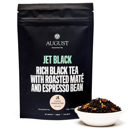 August Jet Black - Roasty Coffee Black Tea in a cup, showcasing the tea's dark color and packaging design.
