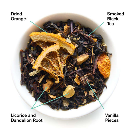 August Mood Indigo - Smoky Orange Vanilla Black tea by August, featuring loose tea leaves and orange peel in a white background.