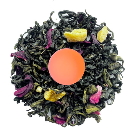 Danfe Peach Green Tea, a loose leaf green tea blend with dried peach and hibiscus, shown in a cup with brewed tea.
