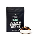 August Silencio - Spicy Pineapple Black Tea displayed in four cups, featuring vibrant tea color and pineapple pieces.