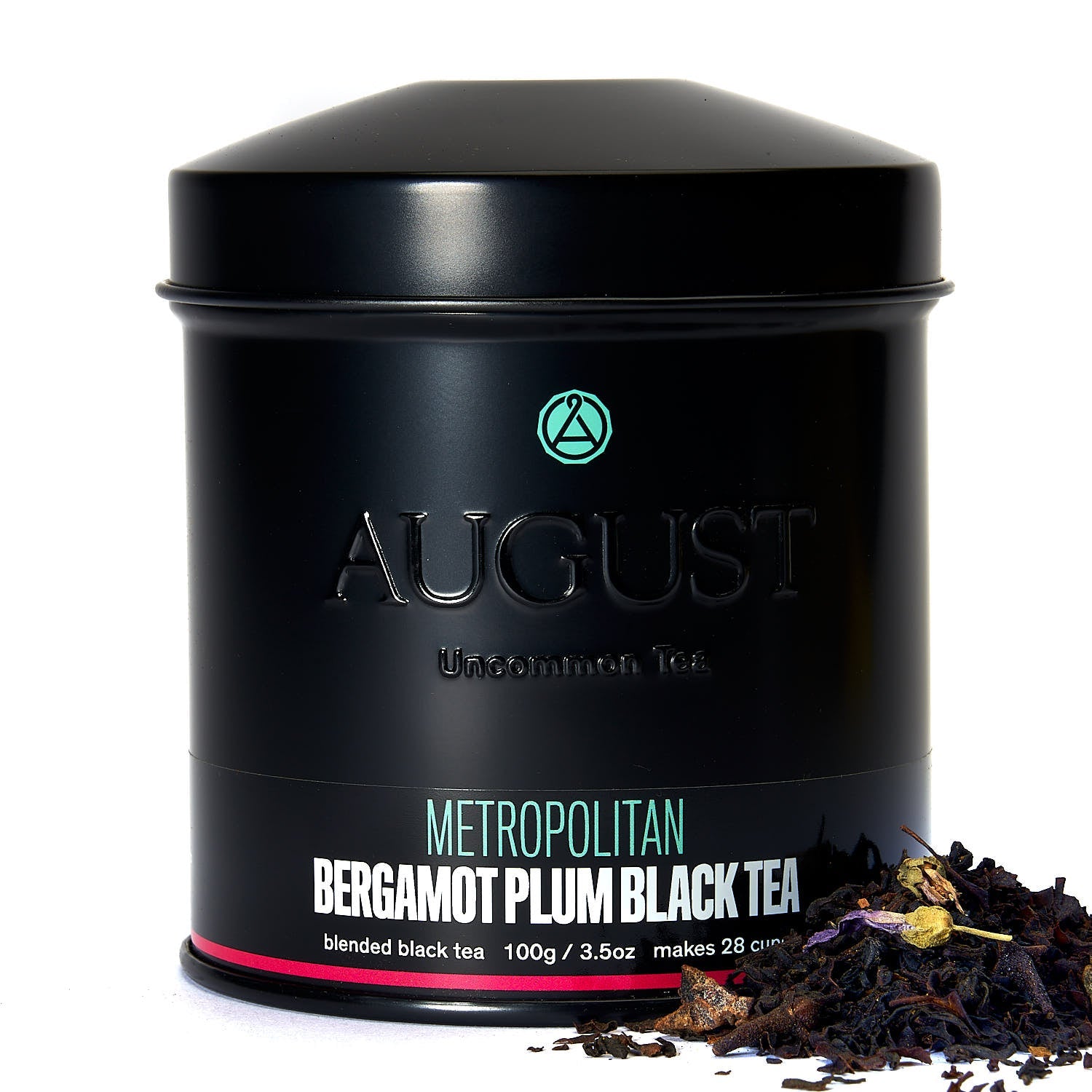 August Metropolitan - Bergamot Plum Earl Grey Black Tea leaves displayed in a tea setting with greenery.