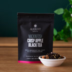 August Mackintosh - Crisp Apple Black Tea in a clear cup, showcasing a brewed tea sample with a rich apple flavor.