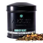 August Know by Heart - Orange Blossom Almond White Tea in a tin container, showcasing the product design and branding.