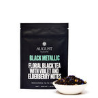 August Black Metallic - Violet Elderberry Black Tea displayed in four cups, showcasing the tea's rich color and texture.