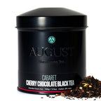 August Cabaret - Cherry Chocolate Black Tea in a tin with tea leaves displayed around it