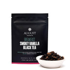 August Breakfast - Smoky Vanilla Black Tea in a cup, showcasing the tea's color and texture in a sample setting.