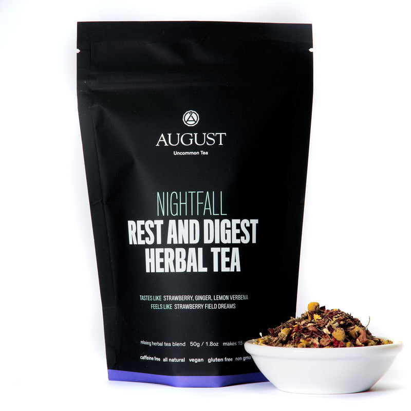 August Nightfall - Rest and Digest Herbal Tea (Caffeine Free) by August, shown in a cup with a tea bag beside it.