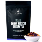 August Mojave - Smoky Hibiscus Cherry Tea in packaging with a cup, showcasing very low caffeine content.