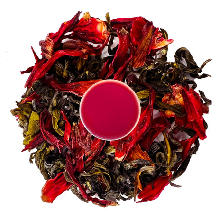 Danfe Hibiscus Green Tea in a clear cup, showcasing the vibrant red infusion with hibiscus petals and green tea leaves.