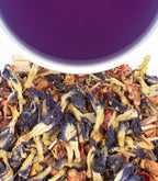 Harney & Sons Indigo Punch, HT Tin of 20 Sachets displayed in a cup with loose tea leaves around it.