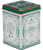 Harney & Sons White Christmas Tea, Tin of 20 Sachets, displayed in a cozy setting with winter elements in the background.