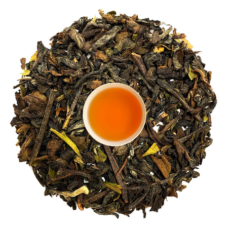 Danfe Nepali Cardamom Spiced Tea (Masala Chai Tea) loose leaf tea leaves steeped in liquid, showcasing a rich amber color.