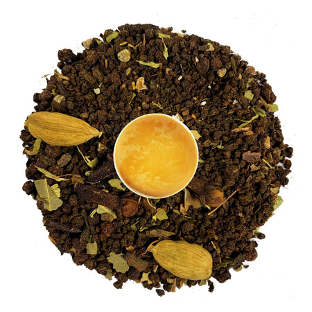 Danfe Yak Mountain Loose Leaf Masala Chai Tea displayed with tea leaves and brewed liquid in a cup, showcasing its rich color.