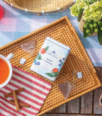 Harney & Sons Berry Cobbler, Tin of 20 Sachets, showcasing the product tin with sachets displayed in a cozy setting.